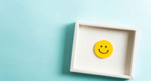 Smiley face in a wooden box on a blue background